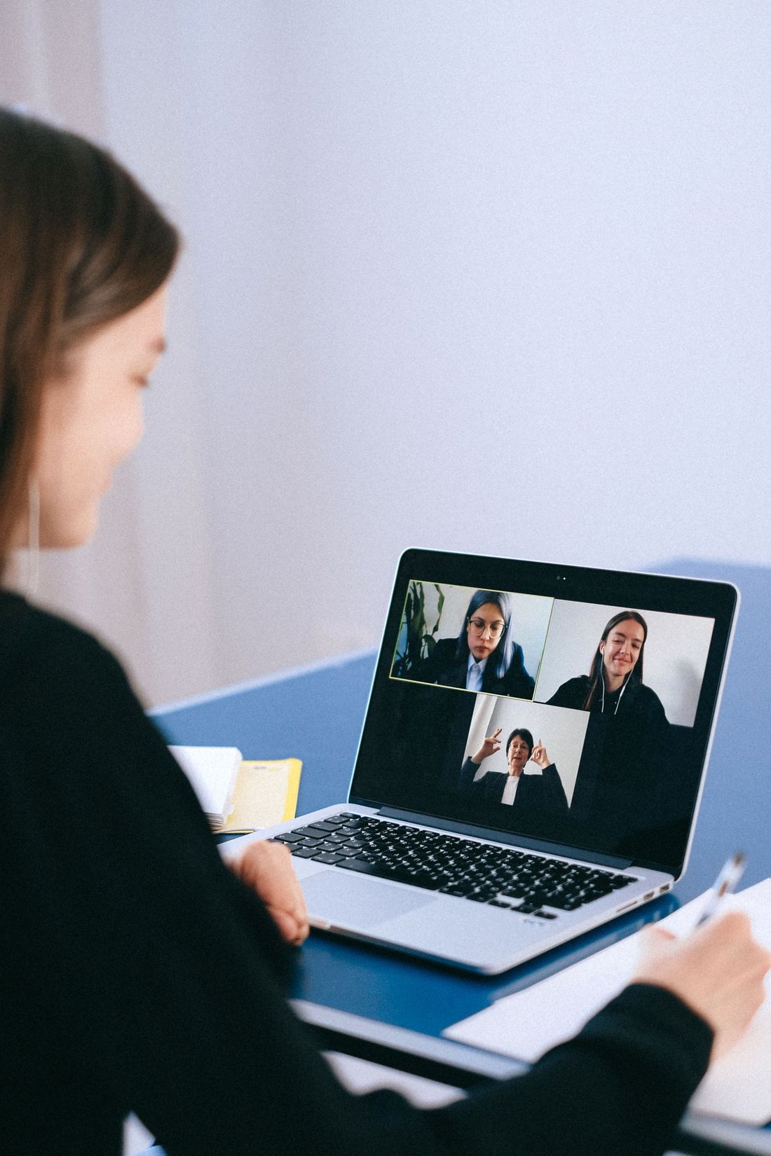 A team member on a video call with colleagues